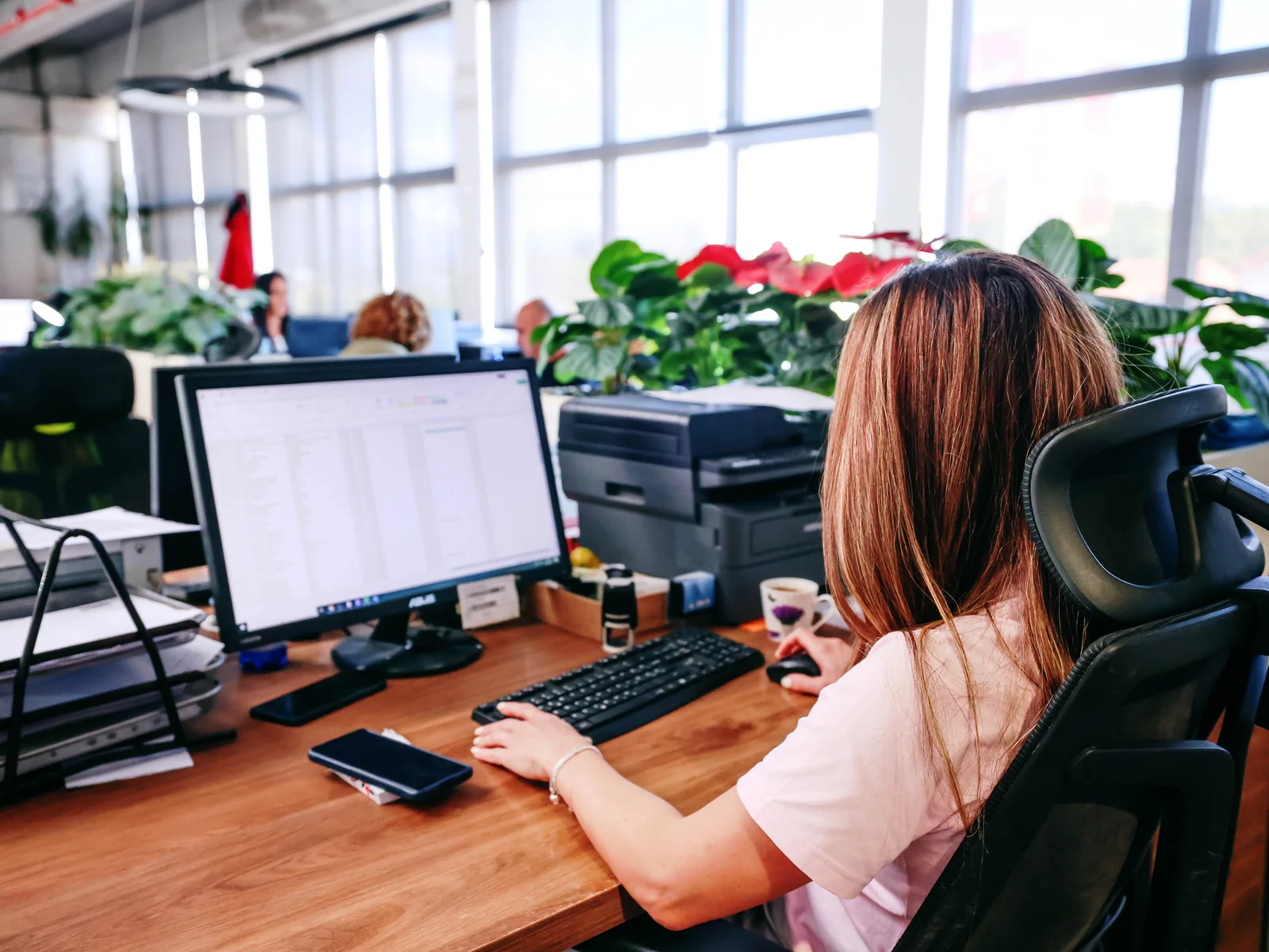 NTC Logistics team member working at a computer in the operations office