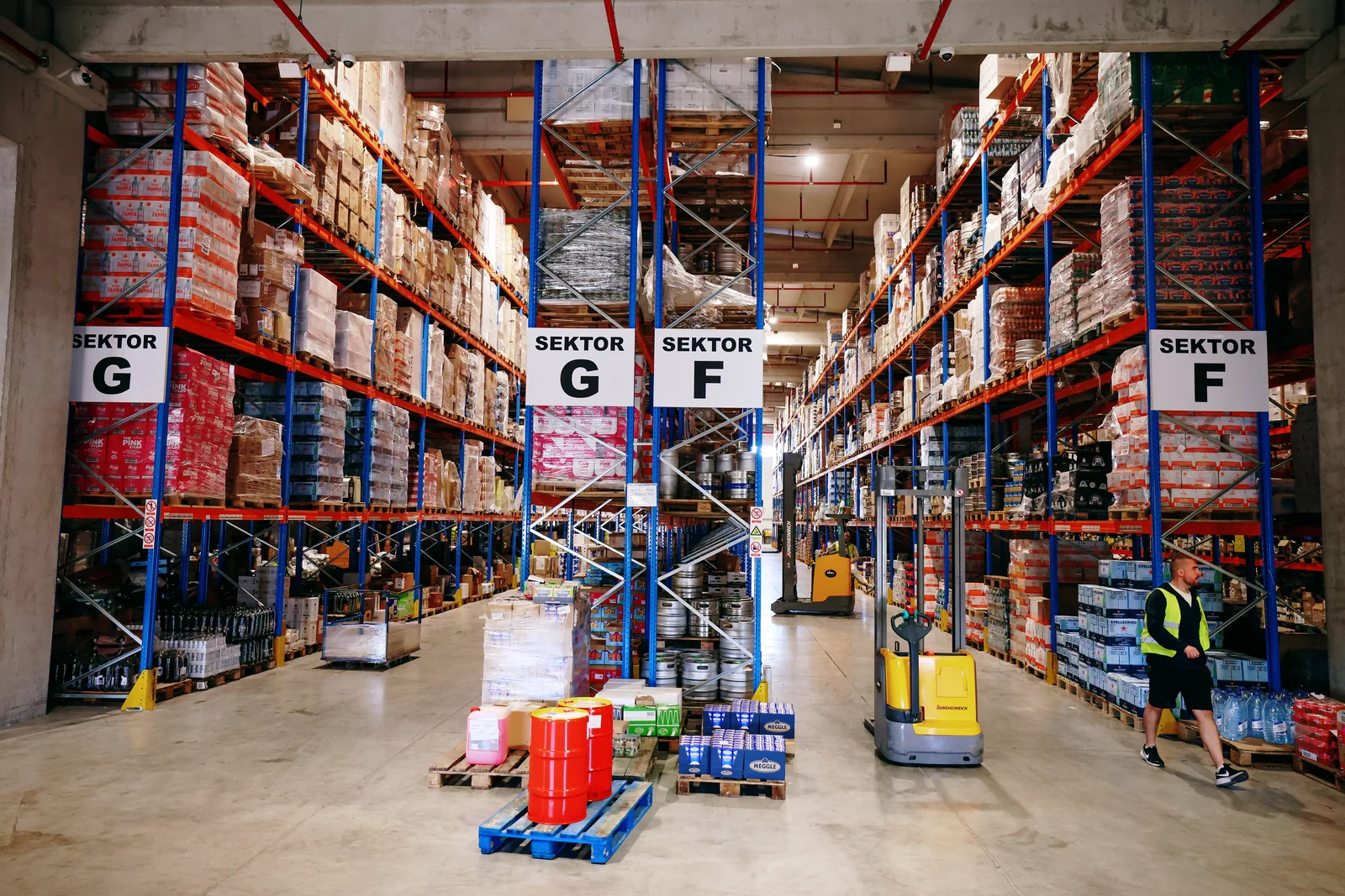Labelled warehouse sectors with goods and pallet handling equipment
